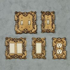 four ornate light switch plates are shown