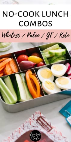 a lunch box filled with veggies, eggs and carrots on top of a table