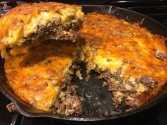 a close up of a pie in a pan on top of a stove with one slice cut out