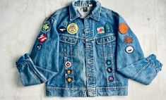 "Be prepared! The motto of the Girls Guides resonates through this rare 1970s Lee denim jacket decorated with 30+ badges and patches celebrating the achievement of young women, camping and other scouting, brownies and guiding events. I'm calling this one \"The Guiding Force\" for all the positive messages it sends. The patches incorporate various style -- printed, embroidered and woven.  Many of these patches were earned by myself, including the \"wings\" from flying up from Brownies. I have fond memories of Camp Ma-kee-wa near Orangeville, Ontario with my best friend Louise. The remaining patches were mostly found on a very cool leather scout's vest while I was thrifting in Los Angeles. I tossed in a couple that of fun ones that reference the camping (Van Gogh's night sky), ghost stories Jean Jacket Patches Ideas, Denim Patches Diy, Patch Denim Jacket, Jacket Patches, Camping Van, Patch Collection