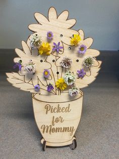 a wooden flower pot with flowers in it that says picked for mommy on the side