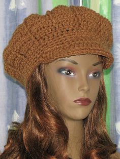 a mannequin head wearing a brown crochet hat