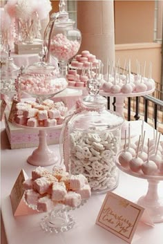 a table topped with lots of candy covered in candies and marshmallows