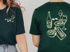 Dinner Club Unisex t-shirt, aesthetic graphic tee, wine shirt, gift for her, gift for wine lover Capturing a vibey night with the best company, sipping wine in low light. What a vibe! The perfect gift for the wine lover in your life. This t-shirt is everything you've dreamed of and more. It feels soft and lightweight, with the right amount of stretch. It's comfortable and flattering for all.  * 100% combed and ring-spun cotton * Fabric weight: 4.2 oz/yd² (142 g/m²) * Pre-shrunk fabric * Side-sea Wine Label Shirt, Restaurant T Shirt Design Ideas, Restaurant T Shirt Design, Restaurant Tshirt Design Ideas, Company T Shirt Design, Company Shirt Design, Restaurant Merch, Graphic Tee Aesthetic, Wine Tshirt