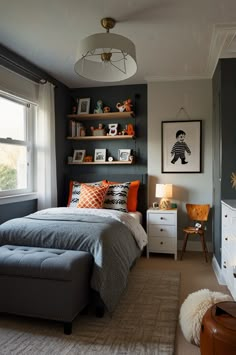 a bedroom with gray walls and orange accents