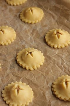 several small pies on a piece of wax paper