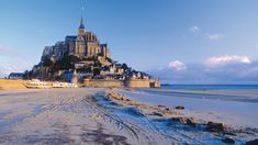 a very large castle sitting on top of a sandy beach