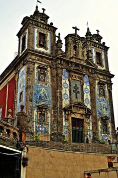 an old building with blue and white tiles on it