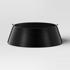 an empty black bowl on a white background