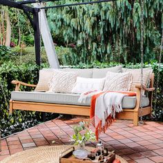 a wooden bench sitting on top of a brick patio