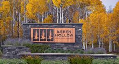 a sign for aspen hollow in the fall