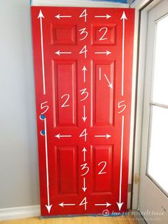 a red door with numbers and arrows painted on it