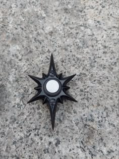 a black object sitting on top of a stone floor