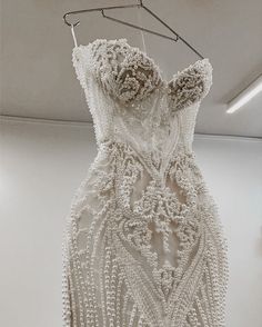 a white dress hanging on a clothes rack