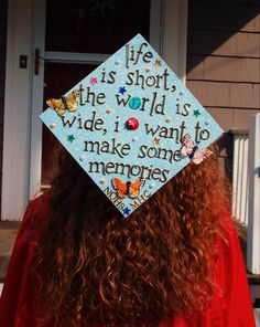 a woman wearing a graduation cap that says life is short the world is wide, i want to make some memories