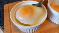 an egg is in a bowl with a spoon