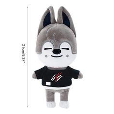 a stuffed animal with a black shirt on it's chest and ears, sitting next to a white background