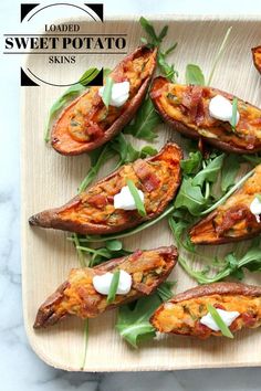 baked sweet potato skins with spinach and goat cheese on a wooden platter, ready to be eaten