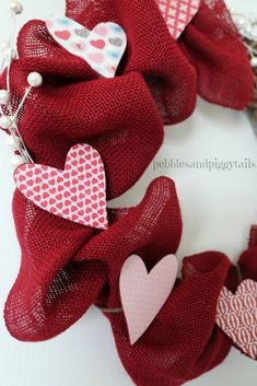 red mesh wreath with hearts hanging from it