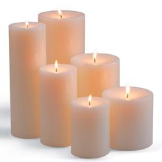 six white candles are lined up in a row