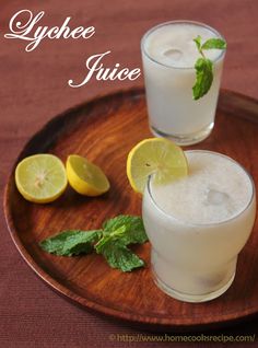 two glasses of lemonade juice on a wooden plate