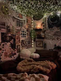 a bedroom with lots of pictures on the wall and lights hanging from the ceiling above it