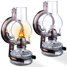 two old fashioned oil lamps sitting next to each other