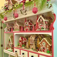 a shelf filled with christmas decorations and gingerbread houses on top of eachother