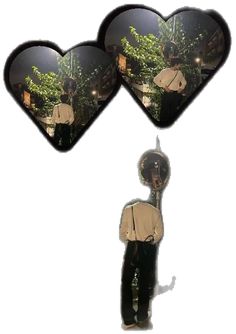 two heart shaped mirrors hanging from the side of a man's head, with trees in the background