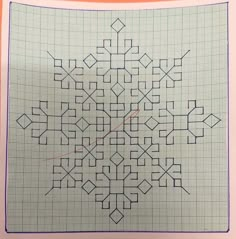 a cross - stitch pattern is shown on a piece of paper