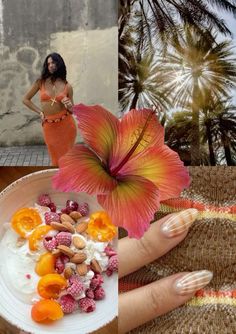 a woman holding a plate with fruit and nuts on it next to a flower that has been placed in front of her