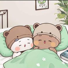 two teddy bears laying in bed next to each other