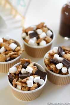 four cups filled with marshmallows and chocolate