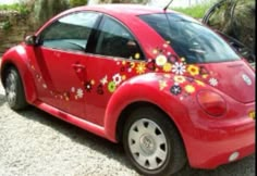 a red car with flowers painted on it's side