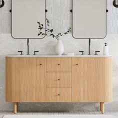 a bathroom vanity with two mirrors above it