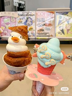 there are two ice cream cones in the shape of animals on top of each other