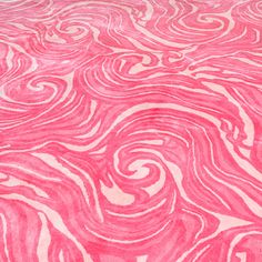 a pink and white rug with swirls on it