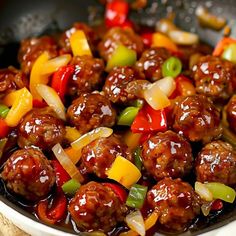 meatballs with peppers and onions in a skillet