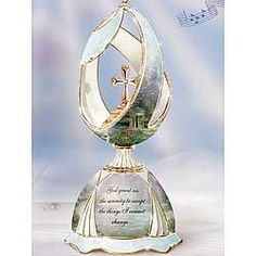 an ornate glass trophy with a cross on top and music notes in the back ground