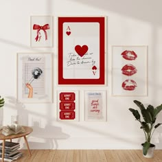 there are many pictures on the wall in this room and one has a red frame