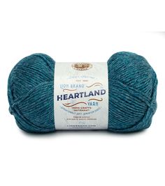 a blue ball of yarn with the words heartland written in white and on it