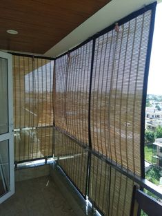 an open window on the side of a building with blinds covering it's windows