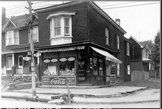 an old black and white photo of a coca cola store