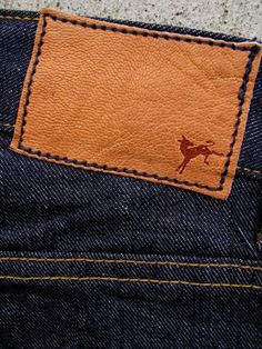 the back pocket of a pair of jeans with an embroidered horse on it's side