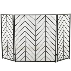 an iron fireplace screen with white painted chevrons on the front and back sides