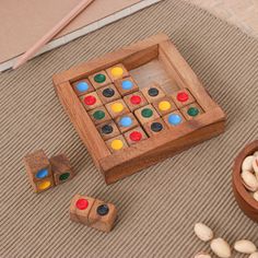 a wooden board game set with dices and nuts on the floor next to it