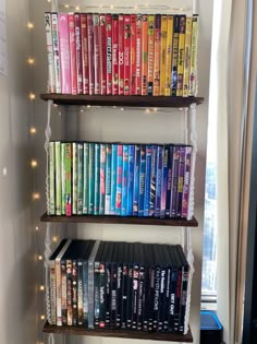 the bookshelf is filled with many movies