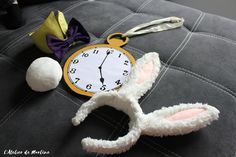 a clock and some bunny ears on a couch