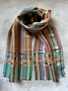 a multicolored scarf hanging on a wall