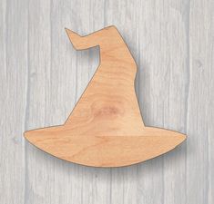 a wooden cutout of a wizard's hat on a wood background with space for text